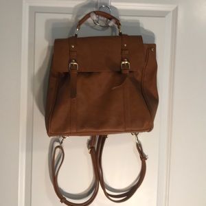 Brown backpack with handle and zip top close